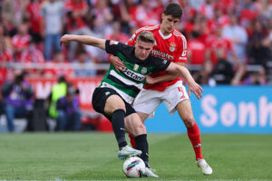 Sporting CP and Benfica players battle for possession during a Liga Portugal match.