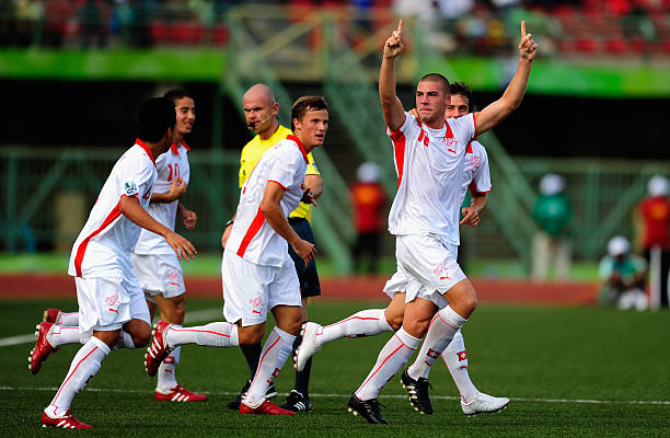 Mexico and Switzerland football players competing during an international friendly match.