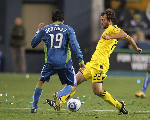 Columbus Crew vs Seattle Sounders match action as two players compete for the ball during an MLS soccer game.